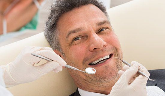 Closeup of smiling man during dental exam