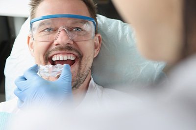 Dentist in Mangum fitting a custom nightguard for a patient