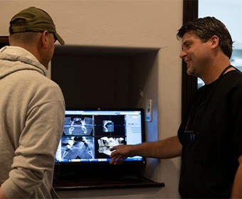 Dentist showing patient dental x-rays