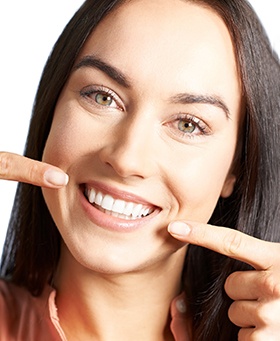 Woman pointing to her teeth