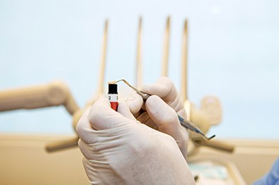 A dentist preparing to apply composite resin