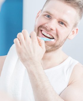 man brushing teeth