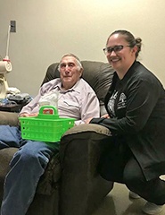 Team member and older patient smiling together