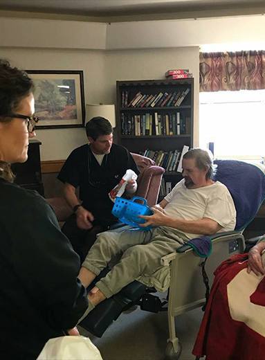 Dentist talking to patient at community event