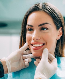 A dentist assessing a patient for cosmetic dentistry