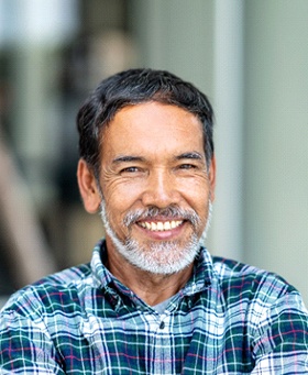 man in a plaid shirt smiling