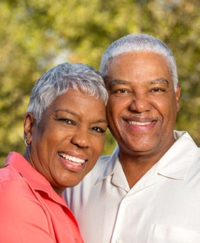 senior couple smiling outdoors