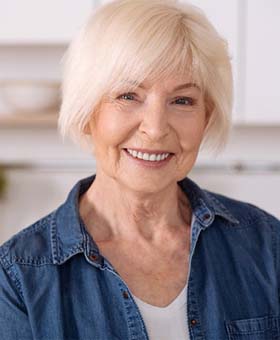 Woman with dental implants smiling in Mangum