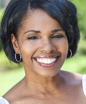 Woman smiling with dental implants in Mangum