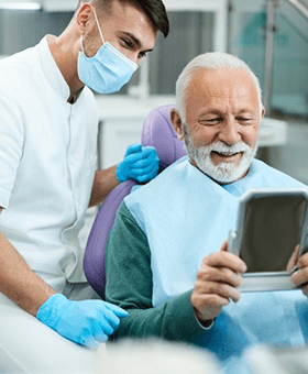 a patient smiling after getting dental implants in Mangum