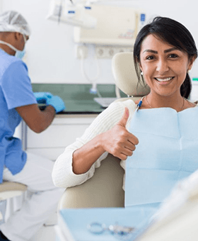 a patient giving thumbs up before getting dental implants
