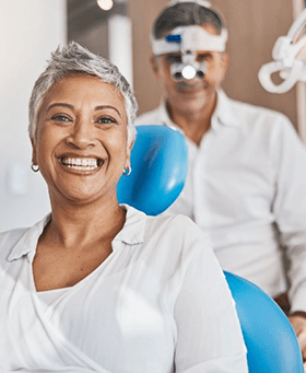 a patient smiling after undergoing dental implant salvage treatment