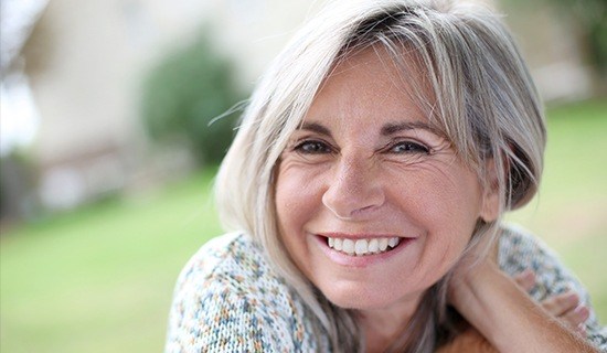 Smiling older woman outdoors