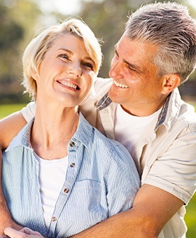 Smiling older man and woman outdoors