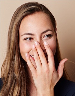 Woman covering her mouth