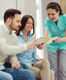 Two patients looking at insurance forms