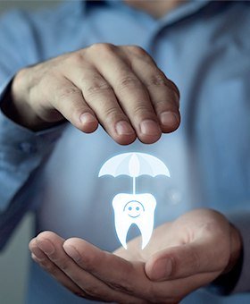 Hand holding an animated tooth under an umbrella