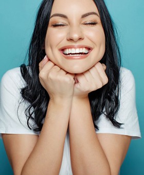 woman smiling after being treated with Invisalign in Mangum 