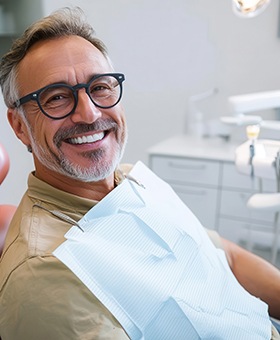 Smiling middle-aged man in dental treatment chair