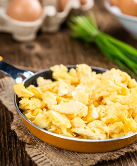 Close-up of a pan filled with scrambled eggs