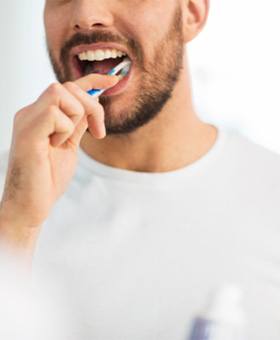 man brushing teeth to prevent dental emergencies in Mangum