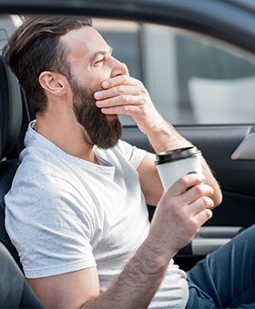 Yawning man driving