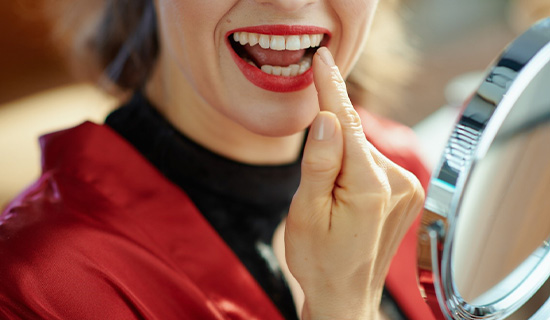 Woman pointing to dental filling in Mangum