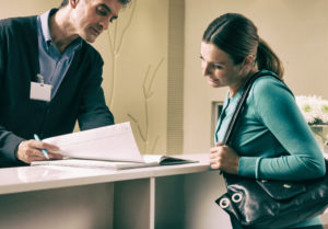 Dentist explaining paperwork to woman patient