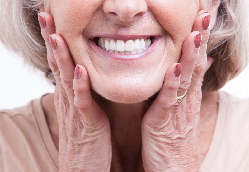 patient smiling after getting dentures in Magnum