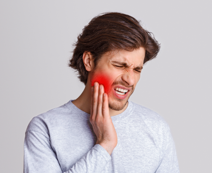 Man holding jaw in pain