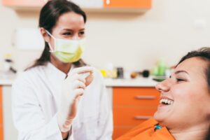Woman smiling after her tooth extraction