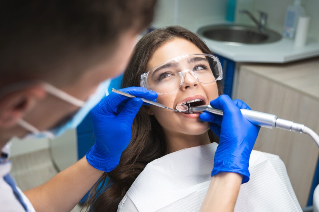 Woman in dental chair looking at dentist as she undergoes root canal